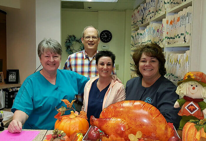 Smiling dentist and dental team members