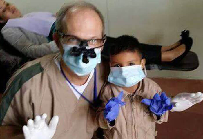 Dr. Mitchell and young boy at community event