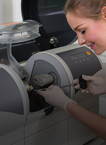 Dental team member working with CEREC unit