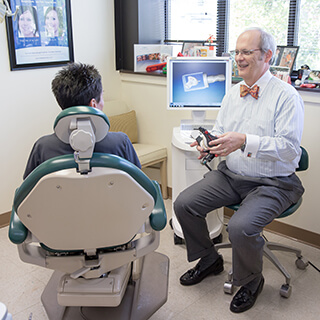 Dr. Mitchell talking to patient in treatment room