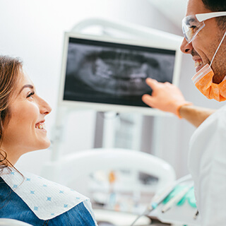 Dentist and patient looking at x-ray