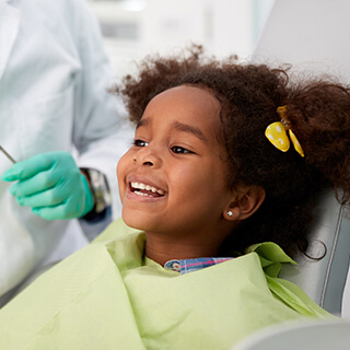 Young girl smiling in dental chair