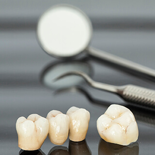 Dental crown and bridge on table